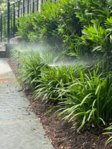 Professional copper backflow preventer installation with irrigation system and landscaped residential property by Advanced Irrigation & Lighting Services serving Northern Virginia, Washington D.C., and Montgomery County, Maryland.