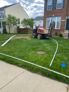 Professional copper backflow preventer installation with irrigation system and landscaped residential property by Advanced Irrigation & Lighting Services serving Northern Virginia, Washington D.C., and