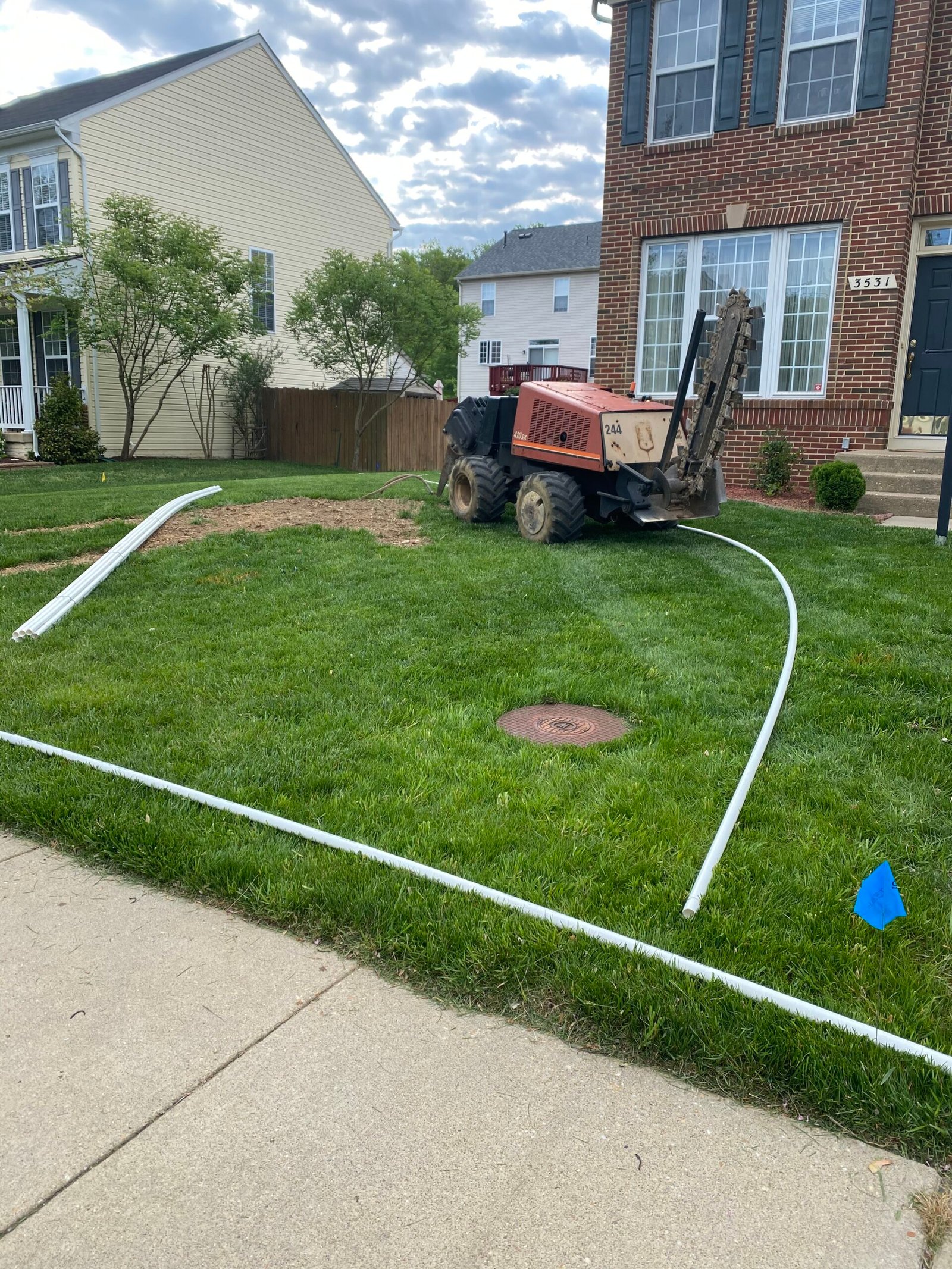 Professional copper backflow preventer installation with irrigation system and landscaped residential property by Advanced Irrigation & Lighting Services serving Northern Virginia, Washington D.C., and