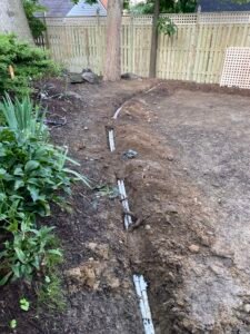 Technician repairing a residential sprinkler irrigation system in Northern Virginia.