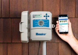 Technician programming and repairing a residential sprinkler controller in Northern Virginia.