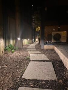 Professional low-voltage LED landscape lighting illuminating a residential home and outdoor walkway in Northern Virginia.