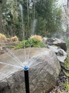 Technician upgrading a residential sprinkler irrigation system with modern water-efficient components in Northern Virginia.