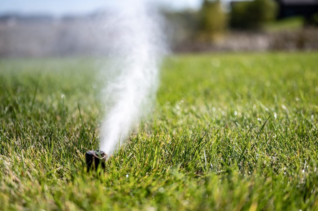 winterizing a irrigation sprinkler system by blowing pressurized air through to clear out water winterization